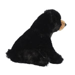 Plush black bear toy on a white background