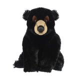Plush black bear toy on a white background