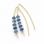 Gold-tone dangle earrings with small blue faceted beads, displayed on a white background.