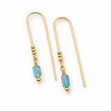 A pair of gold drop earrings with a faceted light blue bead and a small gold bead below, shown on a plain white background.