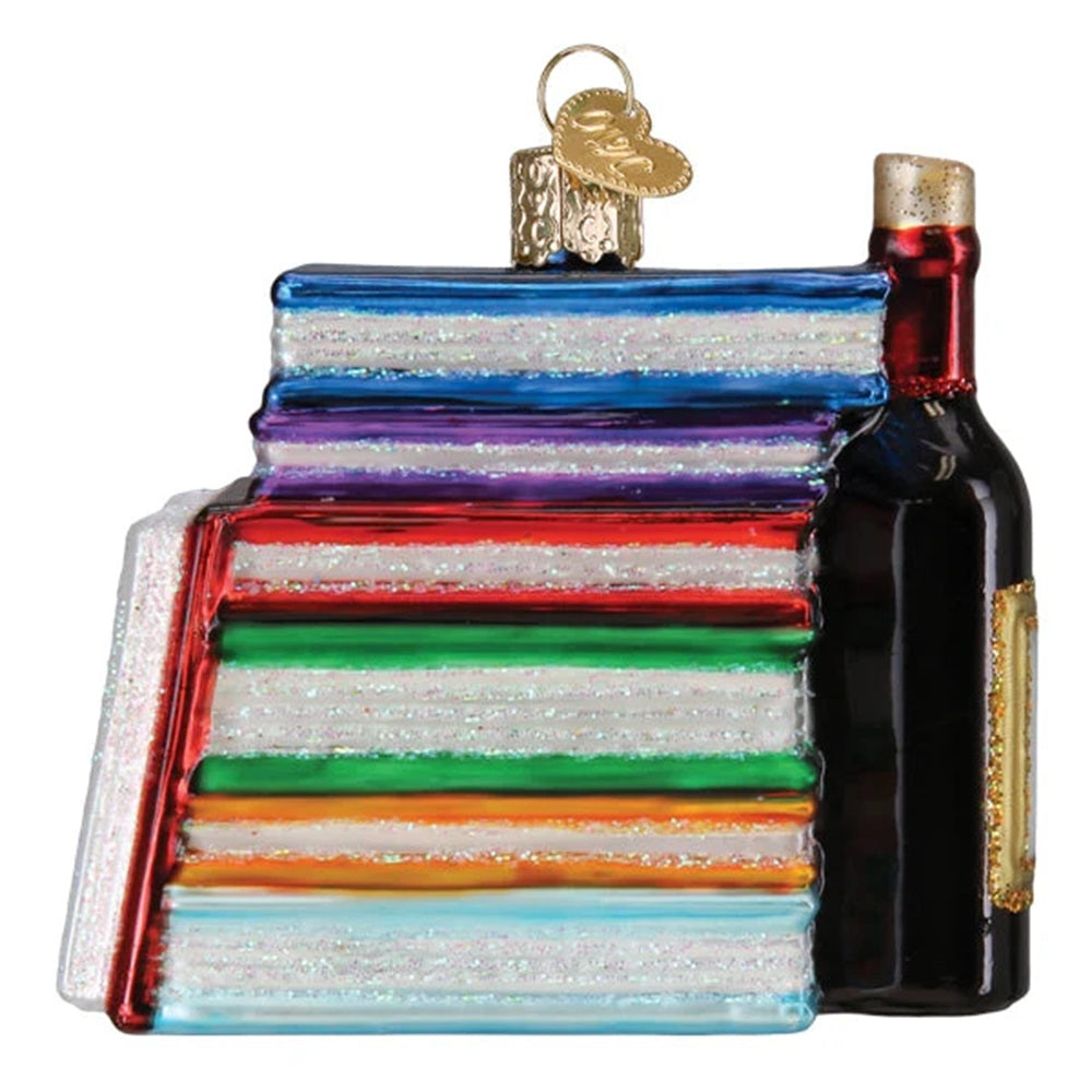 Colorful glass book and bottle ornament on a white background