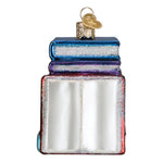 Decorative glass book ornament with a key on a white background