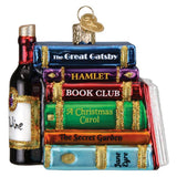 Decorative ornament resembling a stack of books with titles and a wine bottle.