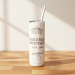 Tumbler with 'Bozeman, Montana' text and building illustration on a wooden surface.