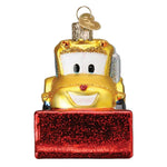 A yellow tow truck Christmas ornament with a red glittery snowplow base, shown on a plain white background.