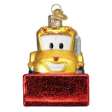 A yellow tow truck Christmas ornament with a red glittery snowplow base, shown on a plain white background.