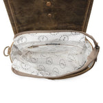 Brown leather bag with white interior lining on a white background