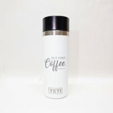 White YETI mug with black lid and 'BUT FIRST Coffee.' text on a white background