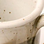 Close-up of a ceramic mug with speckled glaze