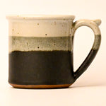 Ceramic mug with two-tone design on a white background
