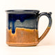Ceramic mug with blue and brown gradient on a white background