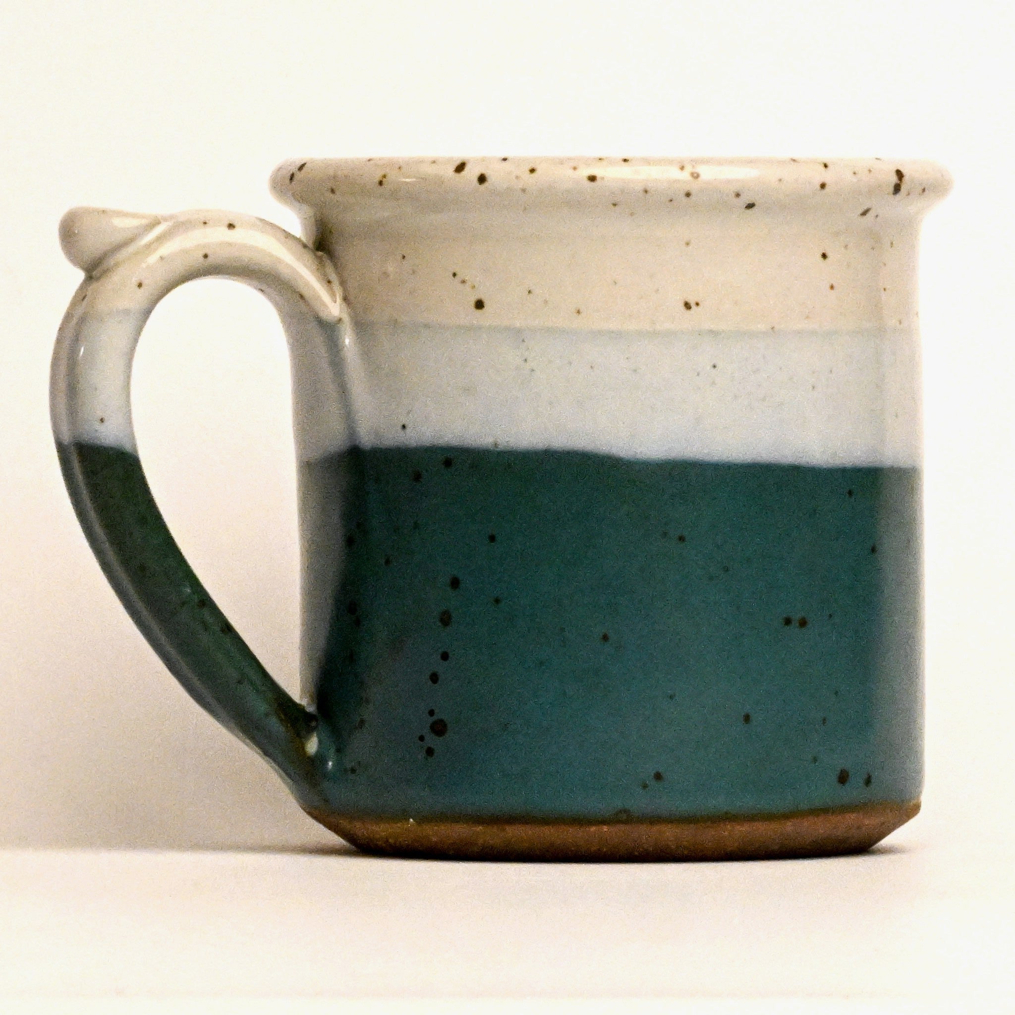 Ceramic mug with a two-tone design on a white background