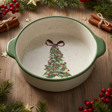 Decorative ceramic bowl with Christmas tree design on a wooden surface with festive decorations.