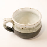 Ceramic bowl with speckled glaze on a white background