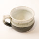 Ceramic bowl with speckled glaze on a white background