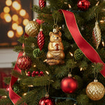 Chipmunk ornament holding an acorn on a white background