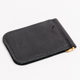 A espresso brown textured leather money clip wallet with a gold-tone metal clip and zipper pull, shown on a clean white background.