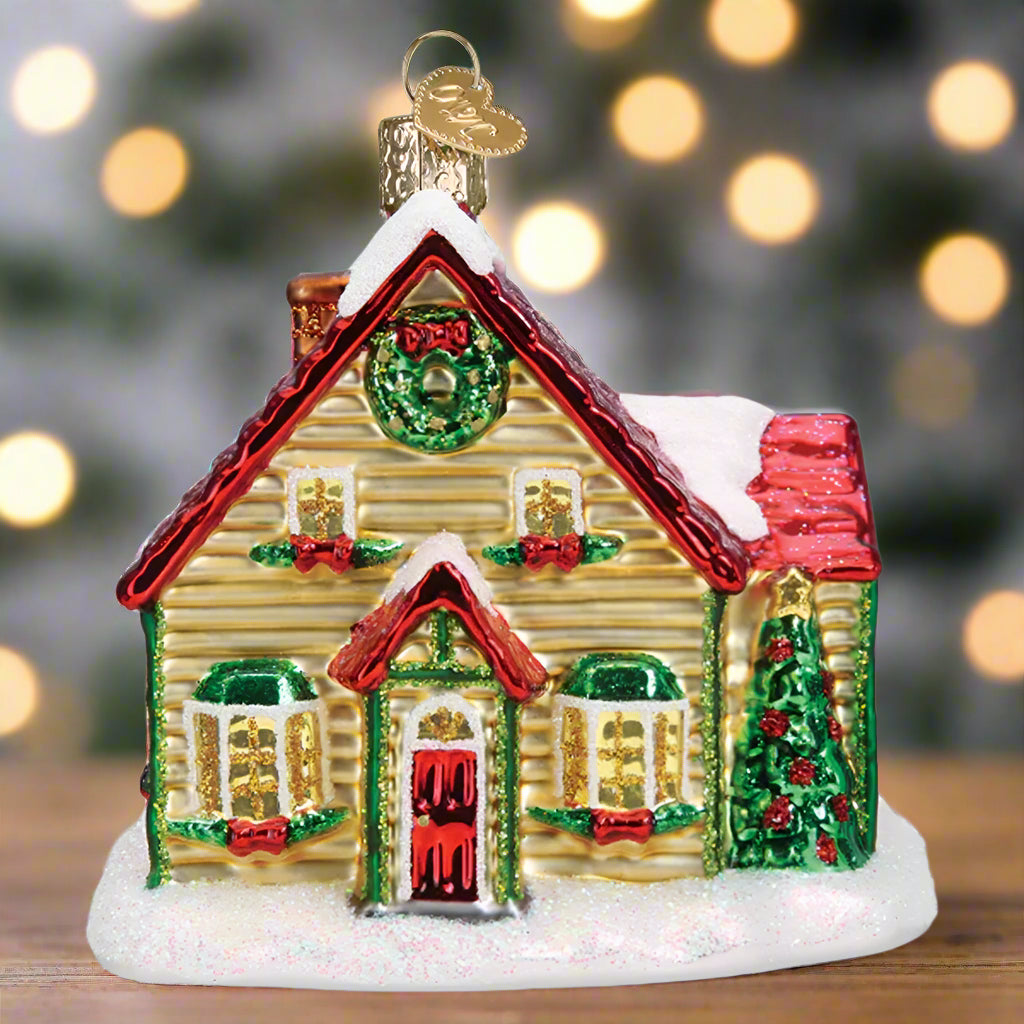 Decorative Christmas house ornament with a wreath and festive decorations on a white background