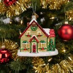 Decorative Christmas house ornament with a wreath and festive decorations on a white background