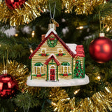 Decorative Christmas house ornament with a wreath and festive decorations on a white background