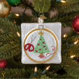Decorative Christmas ornament with embroidery hoop, scissors, and embroidered Christmas tree.