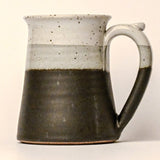 Ceramic mug with two-tone design on a plain background