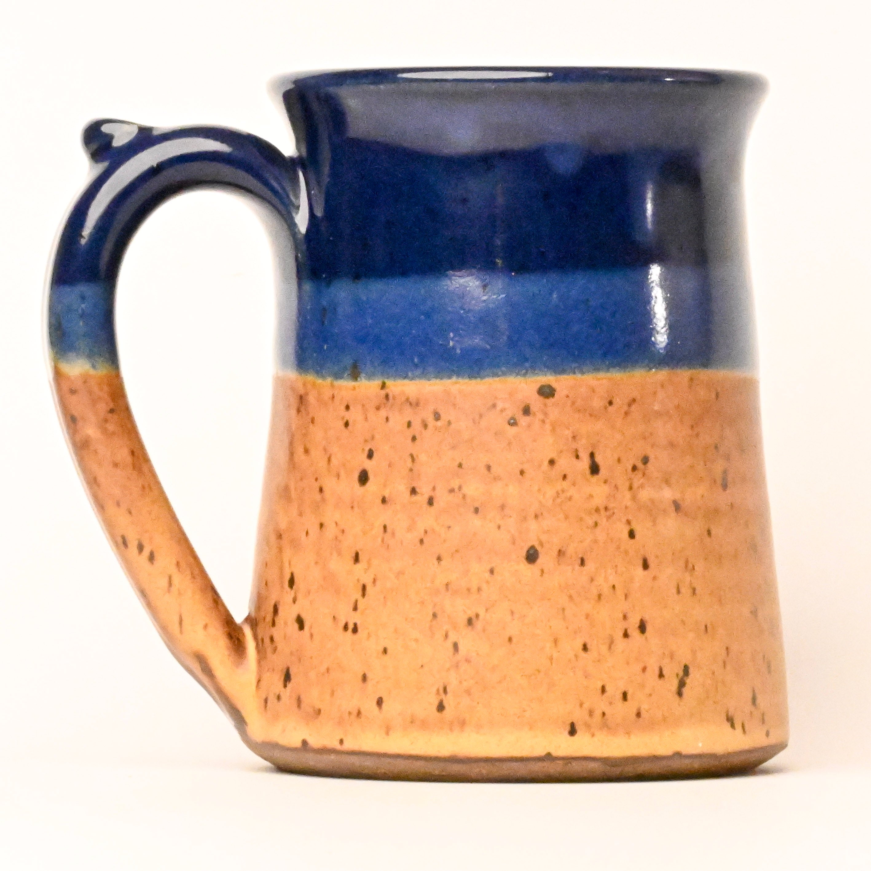 Ceramic mug with blue and brown design on a white background