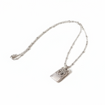 Silver necklace with a pendant on a white background