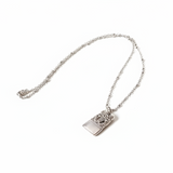 Silver necklace with a pendant on a white background