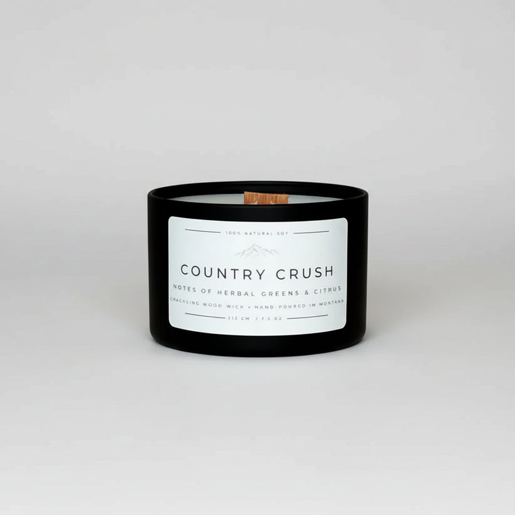 Candle labeled 'Country Crush' on a marble surface with a blurred background