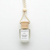A 8 ml reed diffuser bottle by Gallatin Candle Co. in the scent Country Crush, featuring a clear glass bottle with a white label, a wooden cap, and a braided rope handle with a wooden bead, styled on a white background
