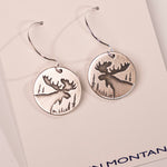 Silver moose earrings on a white card with 'In Montana' text.