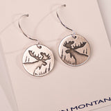 Silver moose earrings on a white card with 'In Montana' text.