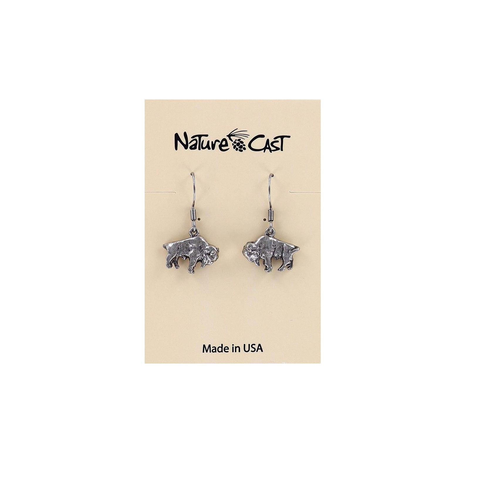 A pair of silver-toned buffalo dangle earrings displayed on a beige Nature's Cast brand card that reads 'Made in USA'.