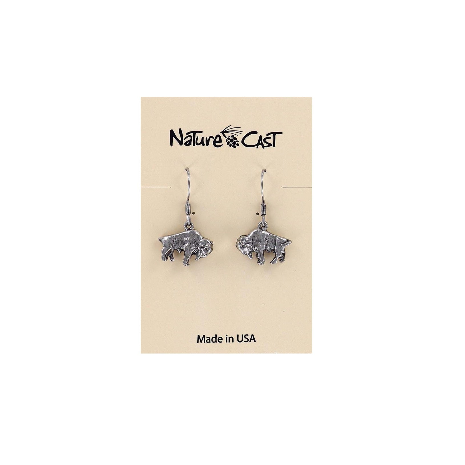 A pair of silver-toned buffalo dangle earrings displayed on a beige Nature's Cast brand card that reads 'Made in USA'.