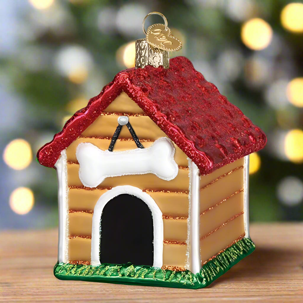Doghouse ornament with red roof and white bone on a white background