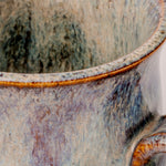 Close-up of a ceramic pot with textured surface and visible glaze.