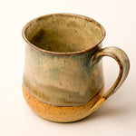 Ceramic mug with a rustic finish on a white background
