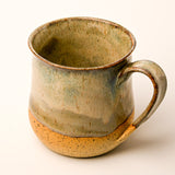 Ceramic mug with a rustic finish on a white background