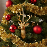 Decorative Christmas tree with gold antler ornament and red balls