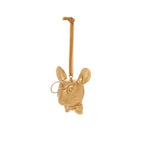 Gold-colored decorative hanging figure of a mouse with a bow tie on a white background