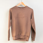 Brown sweatshirt with 'Montana' logo on a hanger against a white background