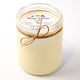 Jar candle with twine bow and 'Montana Farmhouse Candles' label on a white background