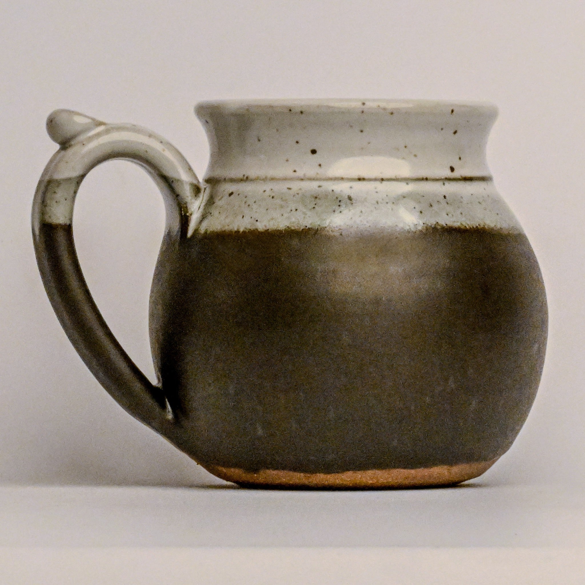 Ceramic mug with a handle on a plain background