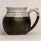 Stoneware mug with a handle on a light gray background