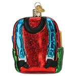 Decorative glass ornament of a red backpack with blue straps on a white background