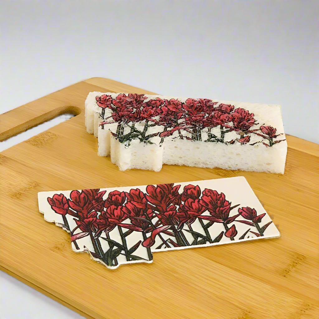 Sponge with floral design on a wooden cutting board