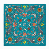 Colorful patterned fabric with birds, flowers, and abstract designs on a blue background