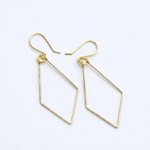 A pair of gold geometric dangle earrings with open diamond-shaped drops and fishhook backings, shown on a clean white background.