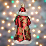 Decorative Christmas ornament of a Santa Claus figure with gold snowflakes on a red coat.